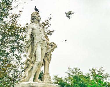 a statue of a man with a bird on his shoulder